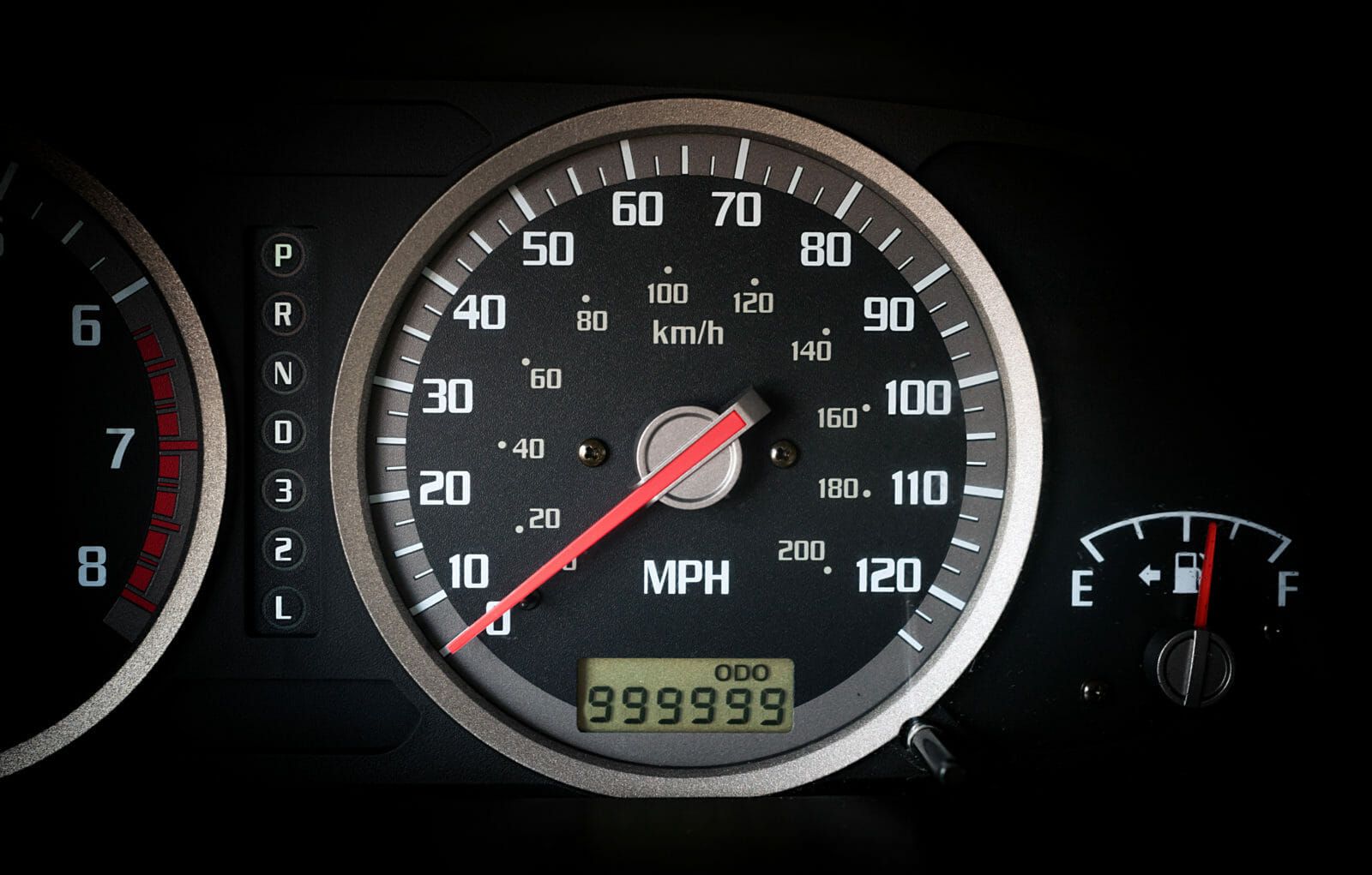 Car dashboard odometer with 999999 miles on it