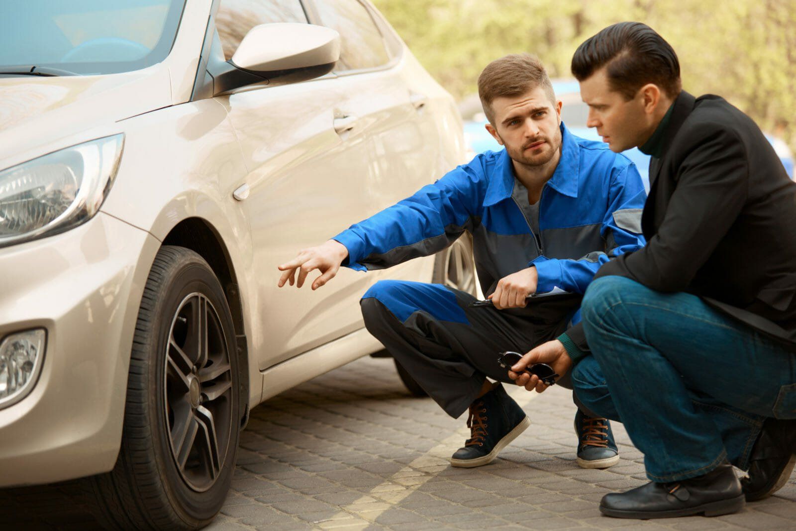 Mechanic and Customer Discussing Problem With Car.