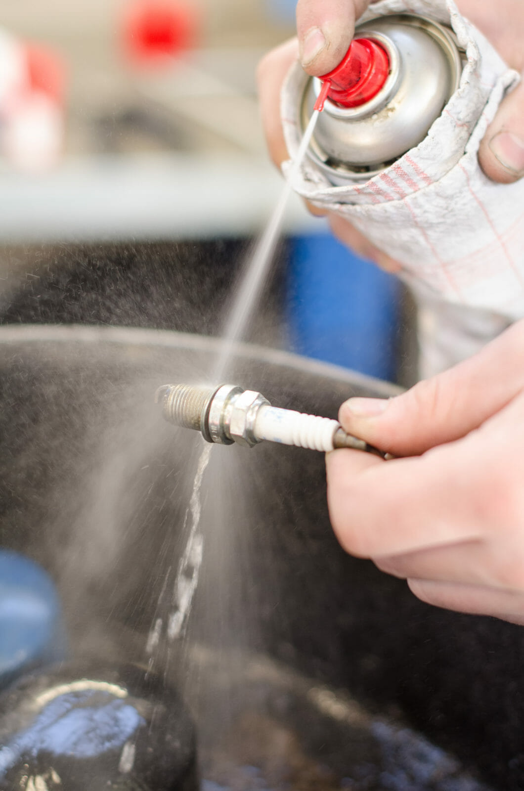 Spark plug cleaning in repair shop.