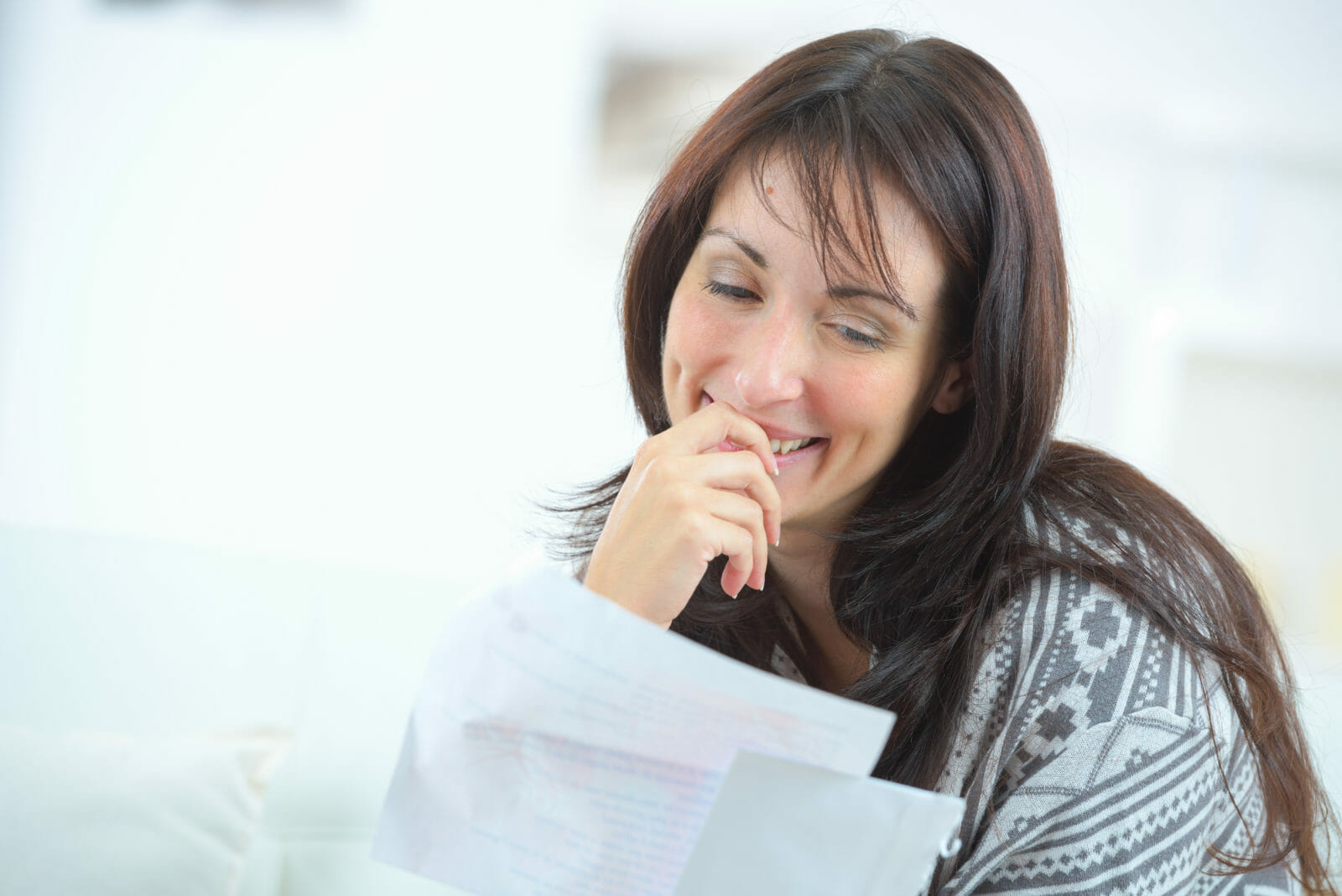 Happy woman reading a letter