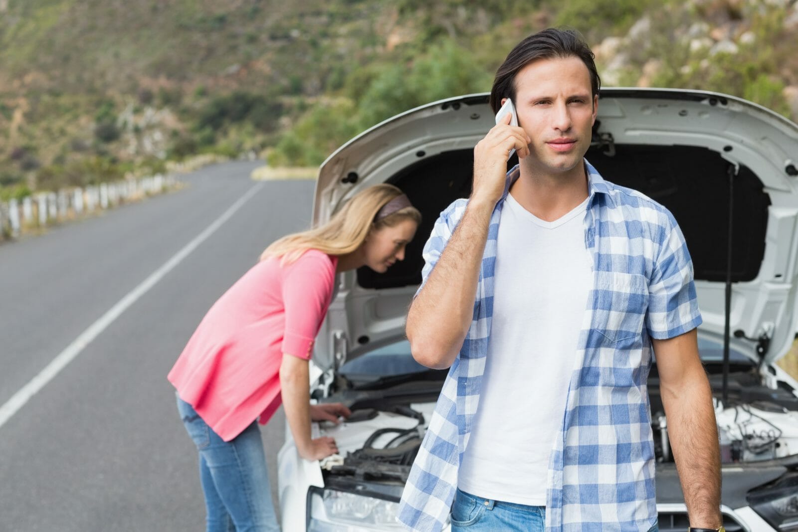 Young couple after a car breakdown